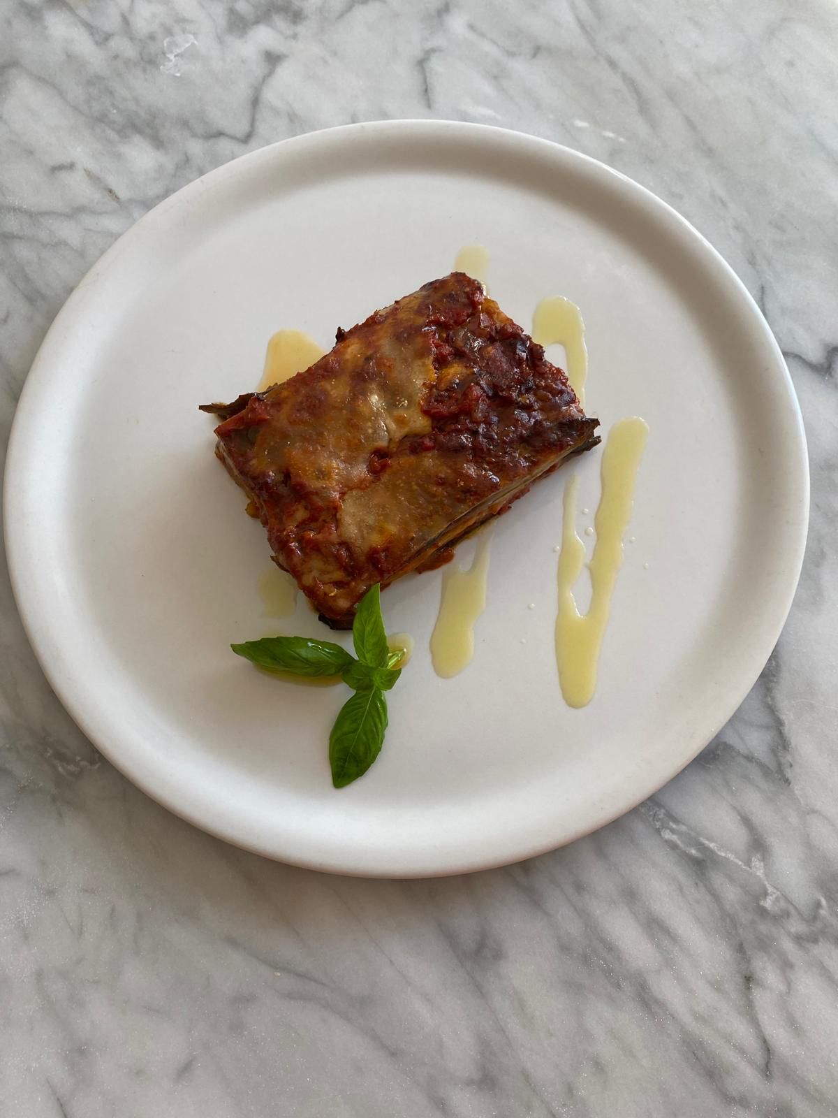 eggplant parmigiana white marble plate