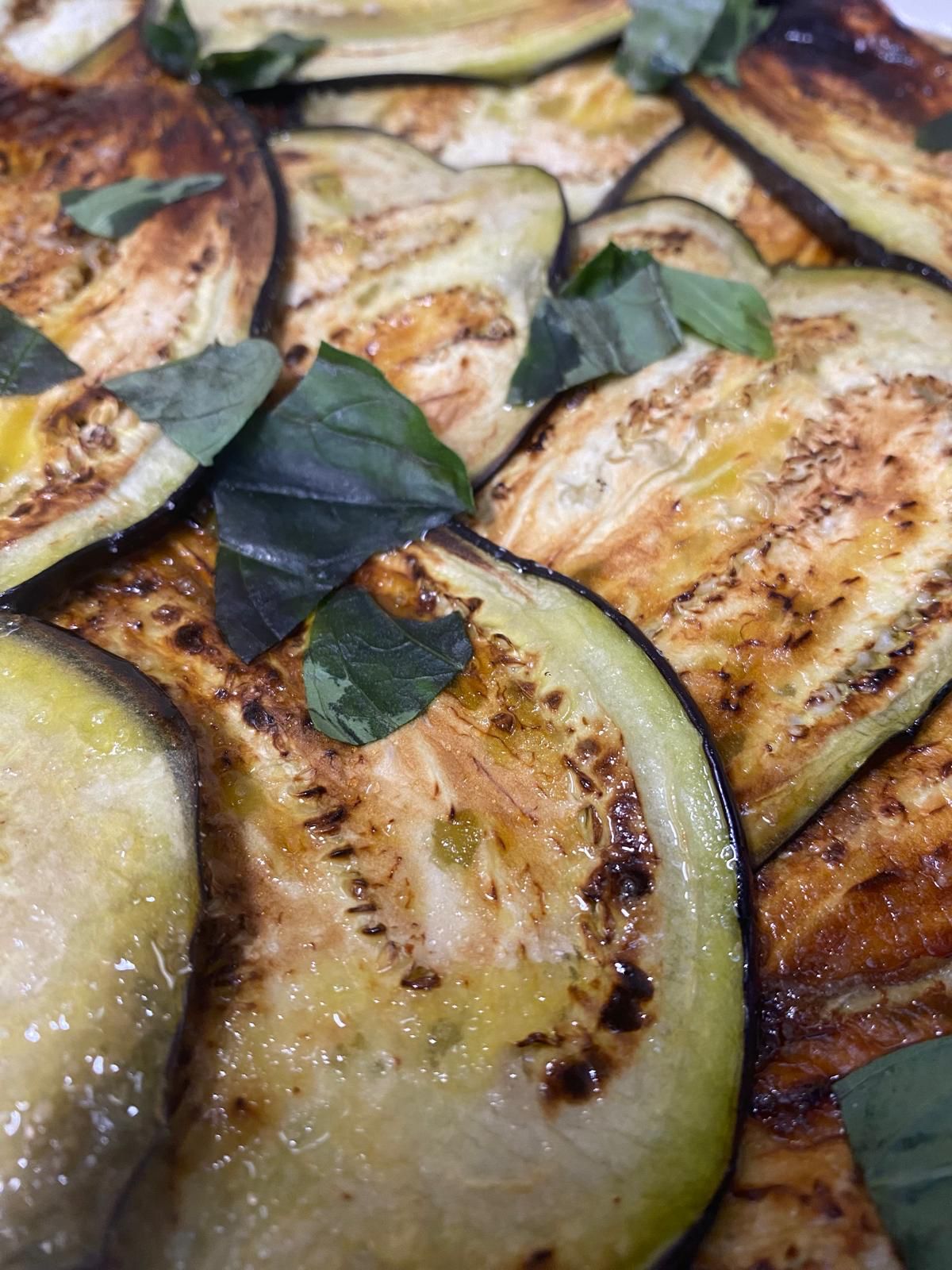 grilled eggplant slices basil leaves