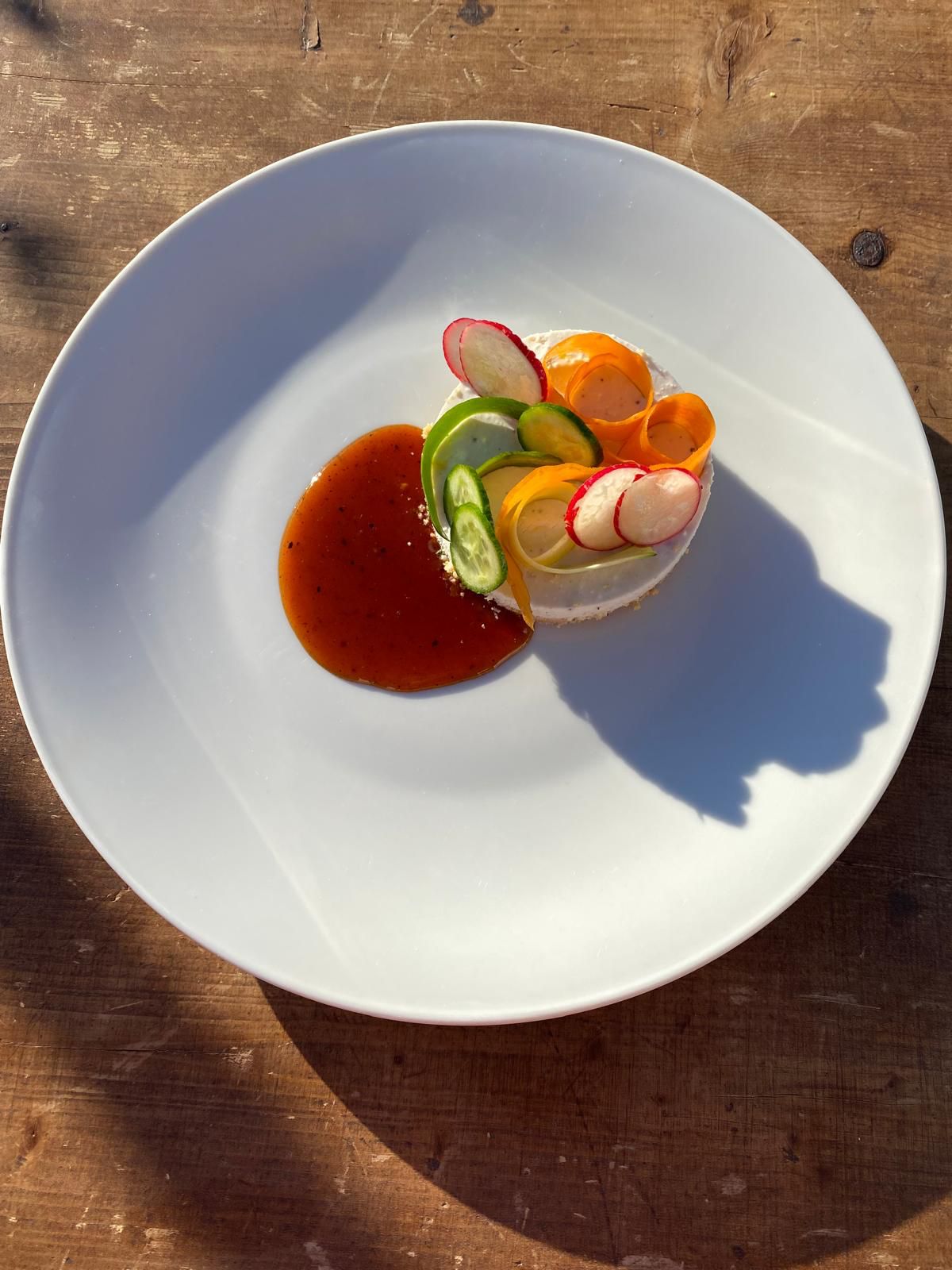 savory cheesecake plated above sauce