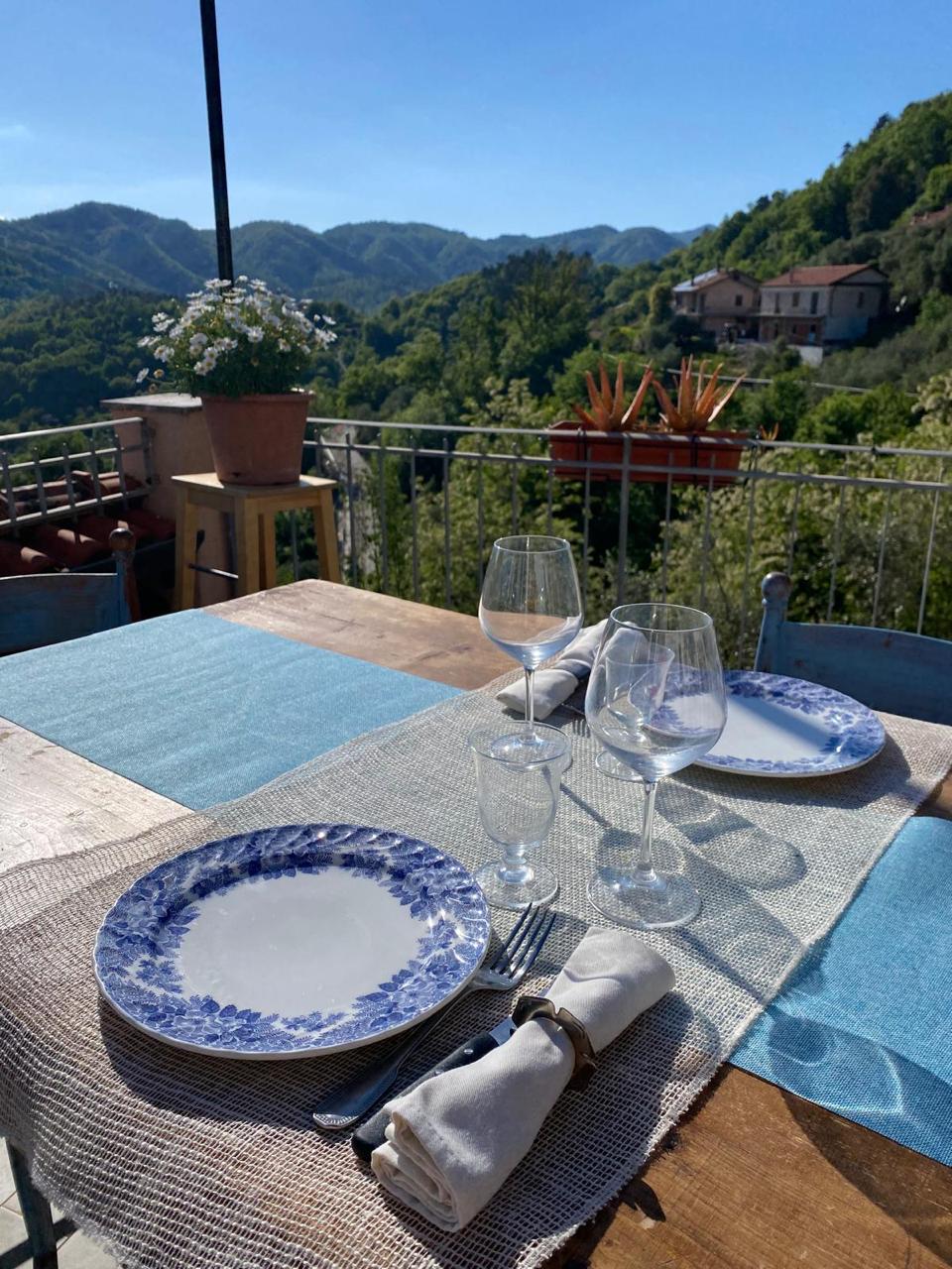 terrace table blue plates mountains