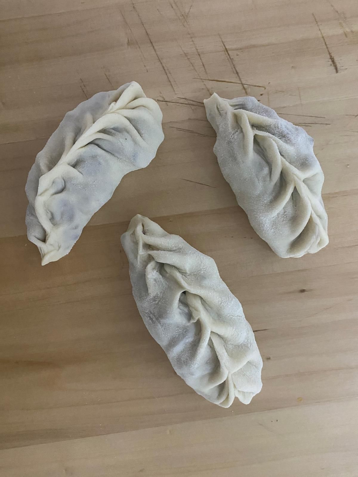 three dumplings wooden cutting board
